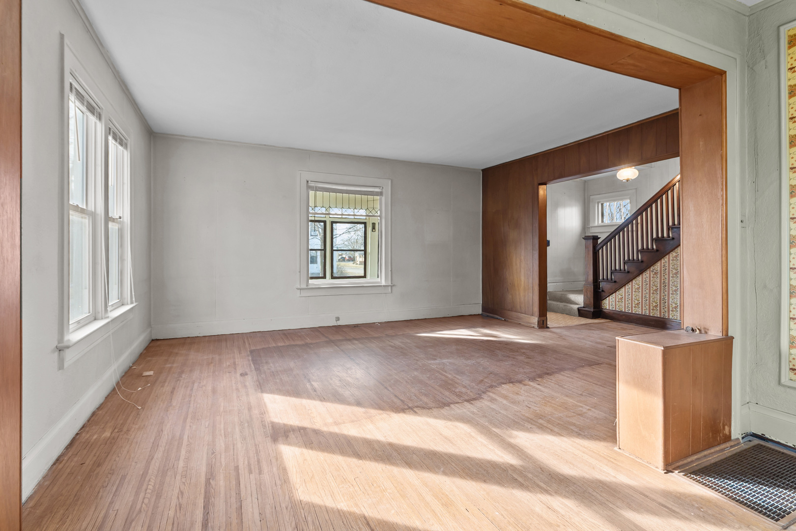 607 West Burbank Street Harvard, IL 60033 - Photo 5 of 22 a view of an empty room with wooden floor and a window