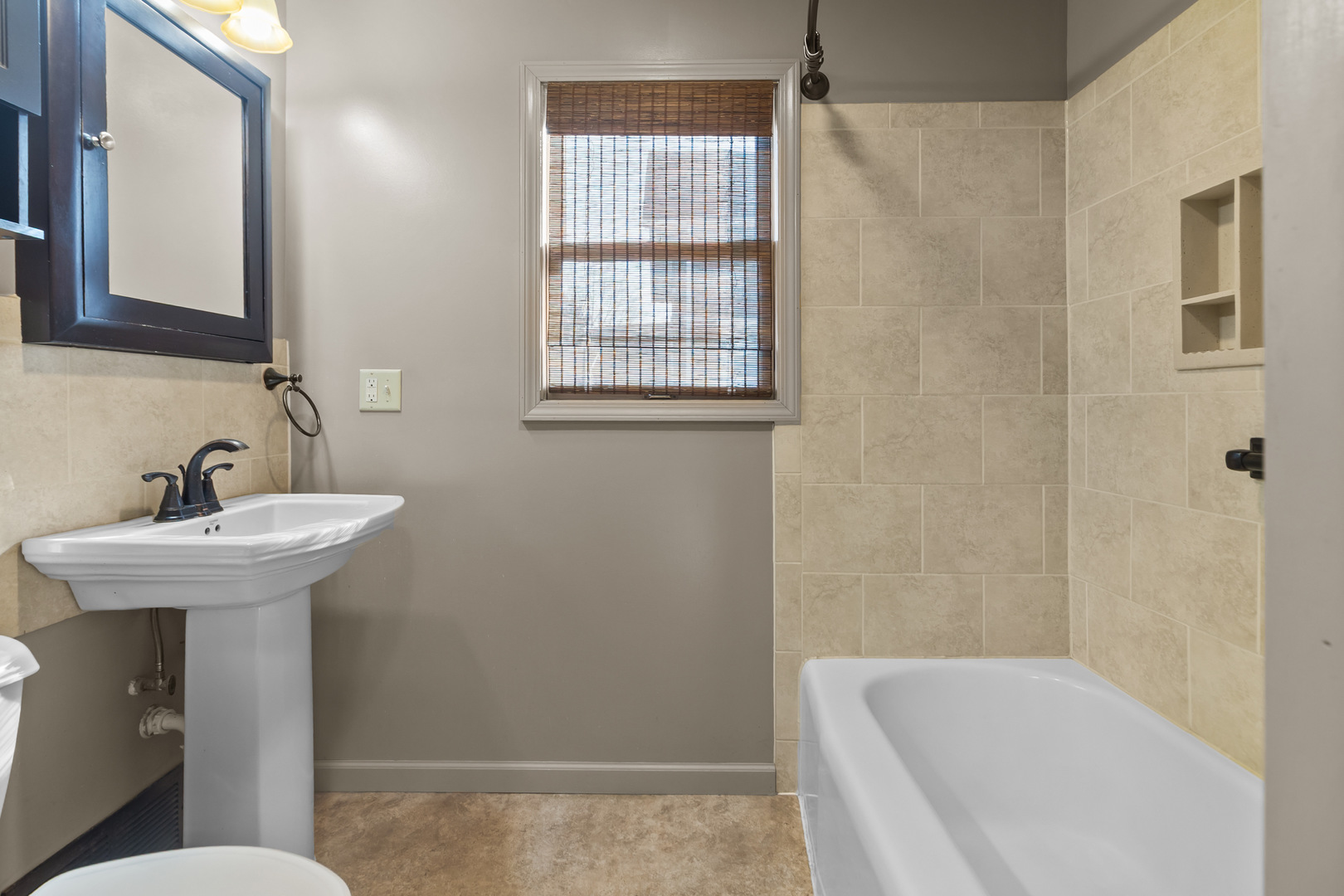 607 West Burbank Street Harvard, IL 60033 - Photo 10 of 22 a bathroom with a sink toilet and shower