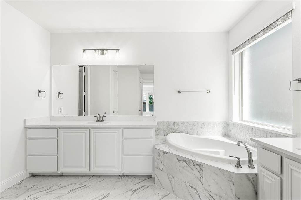 1145 Hitching Post Way Oak Point, TX 75068 - Photo 26 of 39 a bathroom with a sink and a bathtub