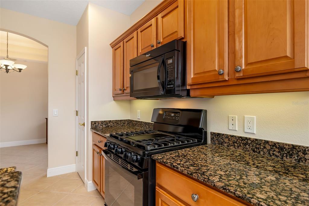 8407 Miramar Way Lakewood Ranch, FL 34202 - Photo 23 of 83 a kitchen with stainless steel appliances granite countertop a stove and a microwave
