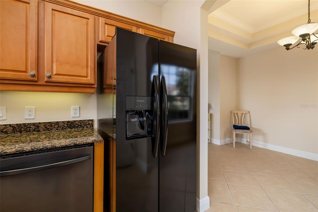8407 Miramar Way Lakewood Ranch, FL 34202 - Photo 27 of 83 a kitchen with a refrigerator and cabinets