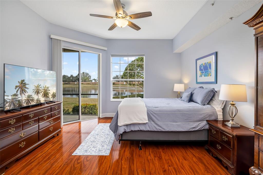8407 Miramar Way Lakewood Ranch, FL 34202 - Photo 35 of 83 a spacious bedroom with a bed and wooden floor