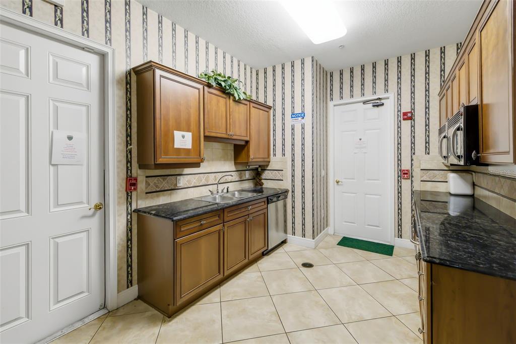 8407 Miramar Way Lakewood Ranch, FL 34202 - Photo 66 of 83 a kitchen with granite countertop a stove and a refrigerator