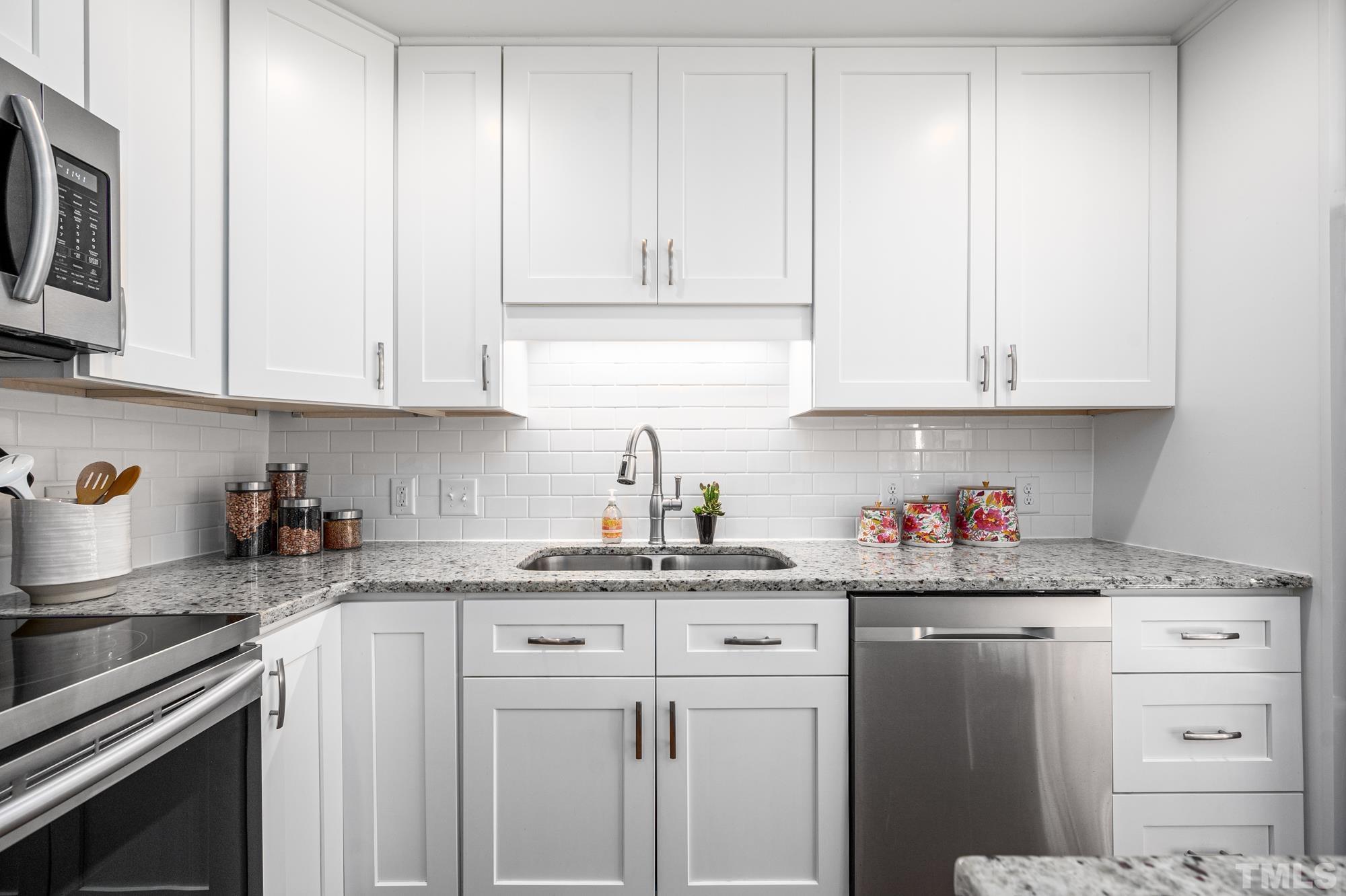 2910 Buckingham Road Durham, NC 27707 - Photo 14 of 30 a kitchen with stainless steel appliances granite countertop white cabinets and sink