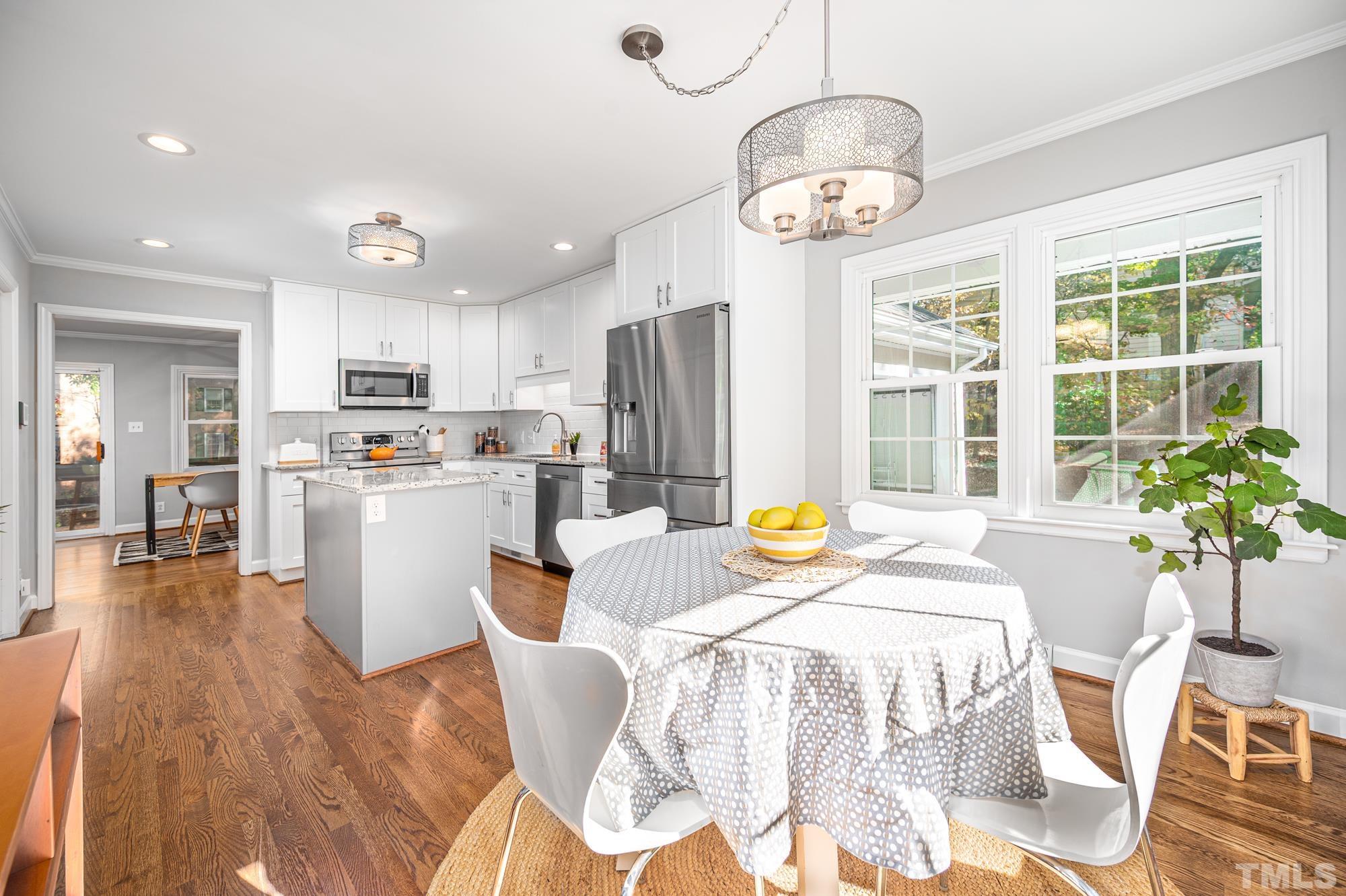 2910 Buckingham Road Durham, NC 27707 - Photo 16 of 30 a living room with stainless steel appliances kitchen island granite countertop furniture and a kitchen view
