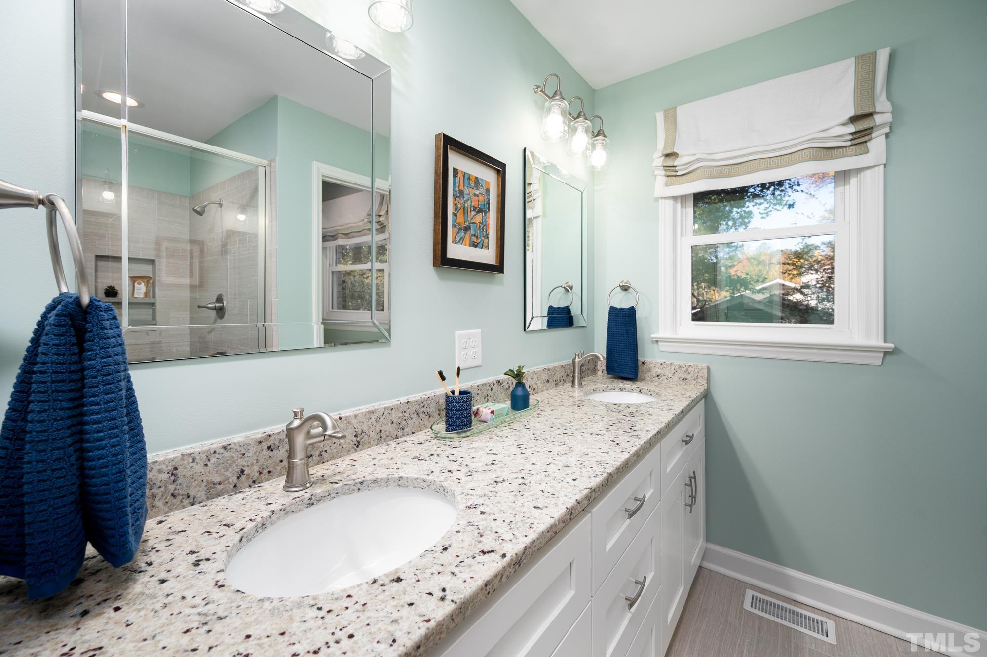2910 Buckingham Road Durham, NC 27707 - Photo 18 of 30 a bathroom with a granite countertop sink and a mirror