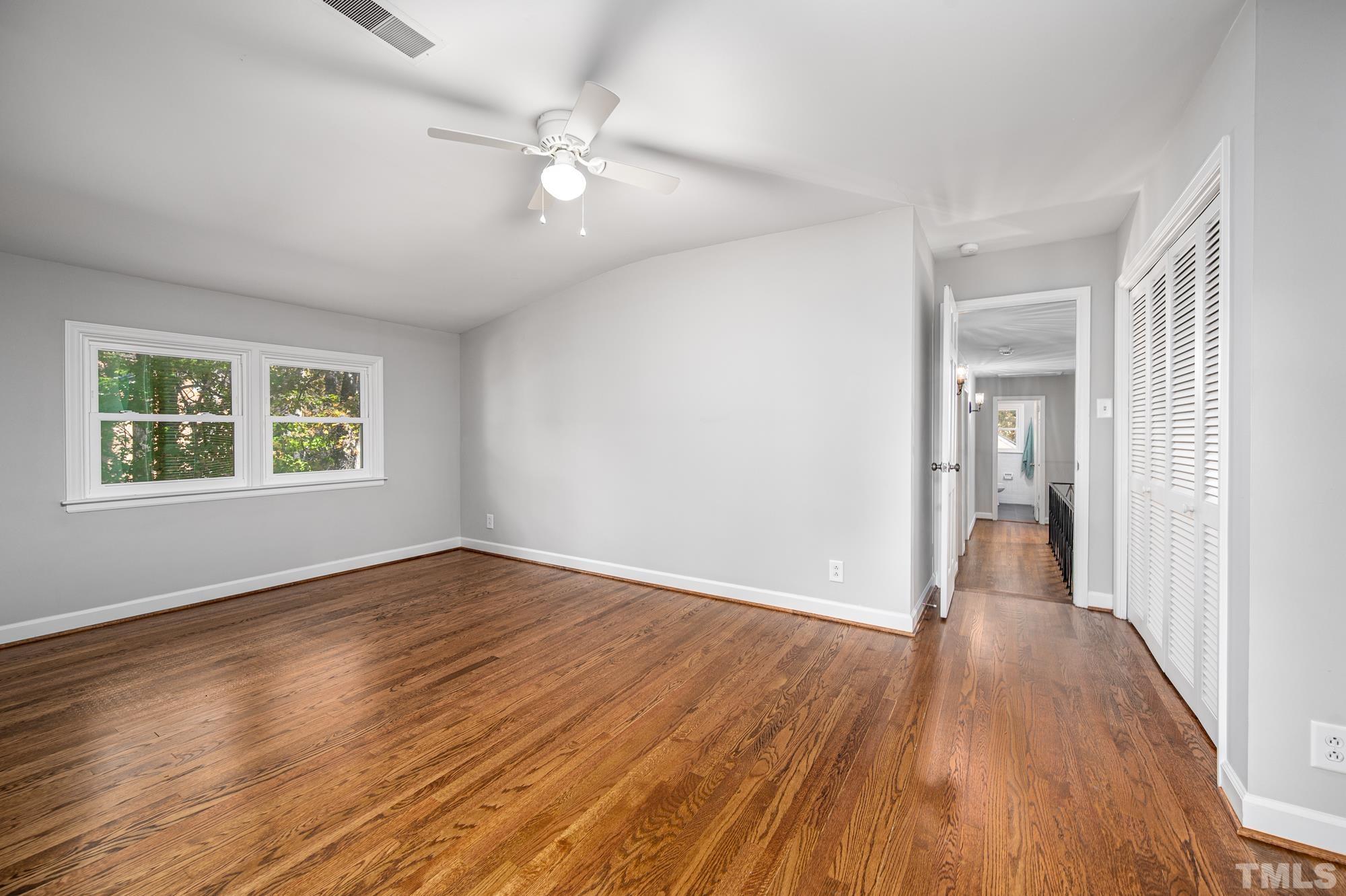 2910 Buckingham Road Durham, NC 27707 - Photo 21 of 30 a view of an empty room with wooden floor and a window
