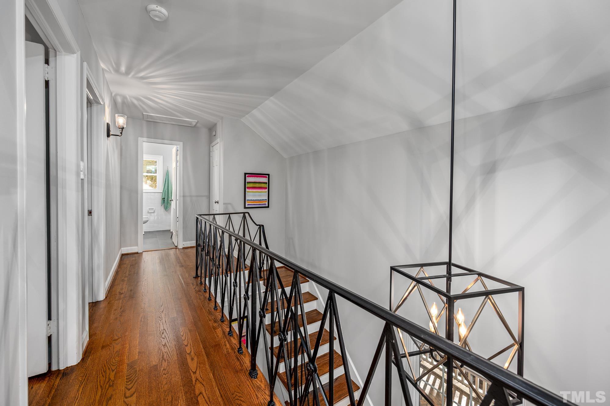 2910 Buckingham Road Durham, NC 27707 - Photo 22 of 30 a view of a hallway with wooden floor and staircase
