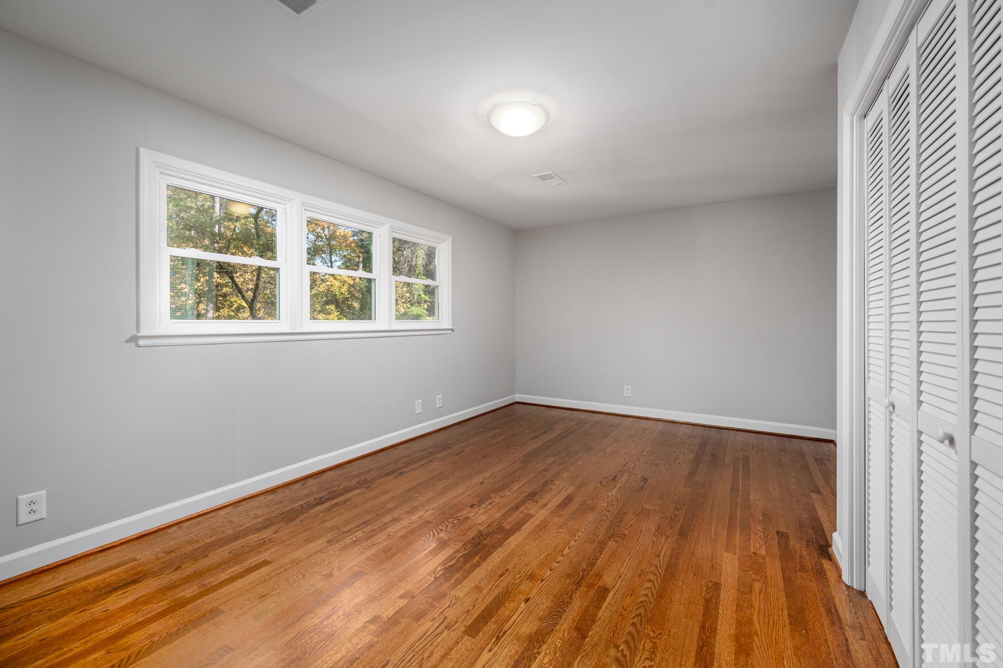 2910 Buckingham Road Durham, NC 27707 - Photo 23 of 30 an empty room with wooden floor and windows