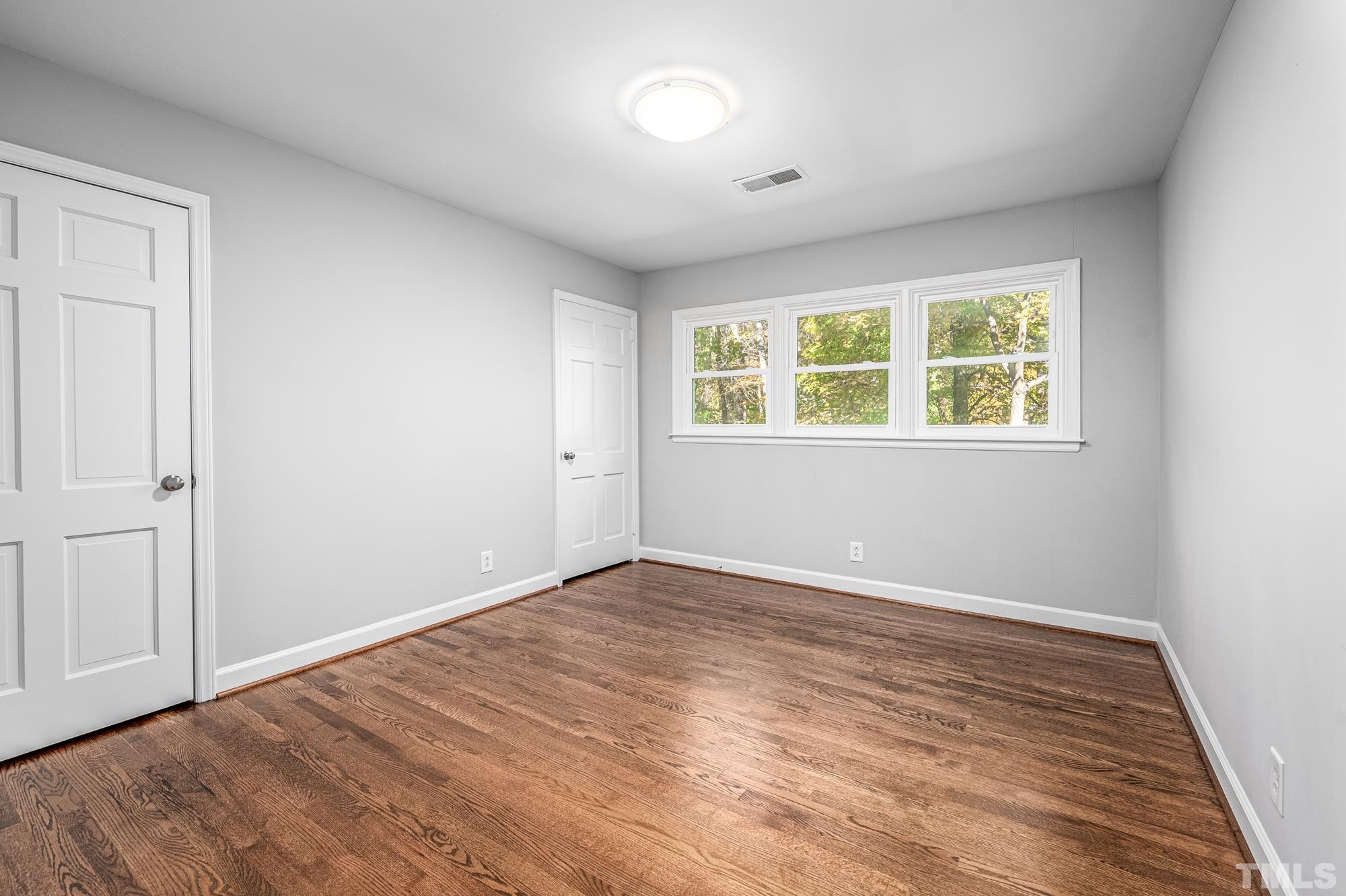 2910 Buckingham Road Durham, NC 27707 - Photo 25 of 30 an empty room with wooden floor and windows