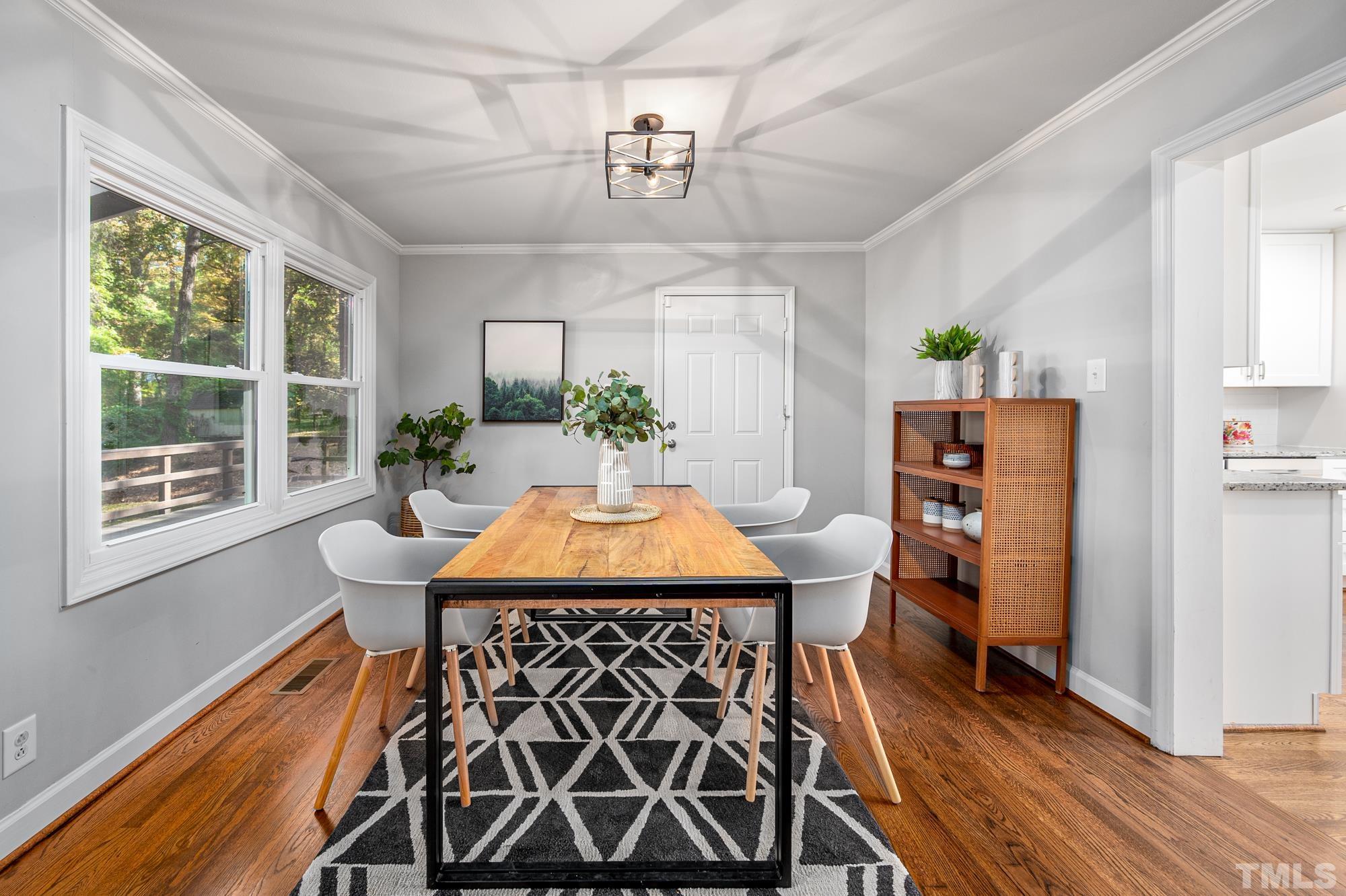 2910 Buckingham Road Durham, NC 27707 - Photo 10 of 30 a view of a dining room with furniture window and wooden floor