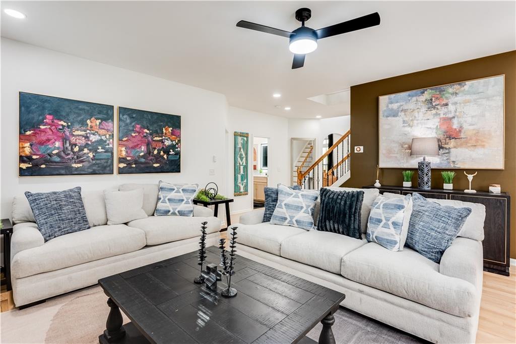 3135 Esplanade Circle Southwest Atlanta, GA 30311 - Photo 18 of 69 a living room with furniture a couch and paintings on the wall
