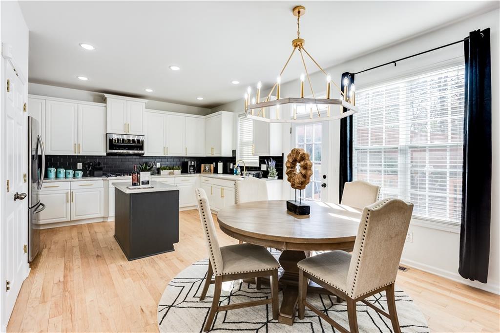 3135 Esplanade Circle Southwest Atlanta, GA 30311 - Photo 20 of 69 a kitchen with a dining table chairs and refrigerator