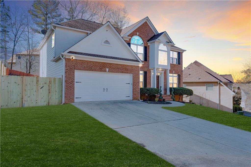 3135 Esplanade Circle Southwest Atlanta, GA 30311 - Photo 2 of 69 a front view of a house with a yard and garage
