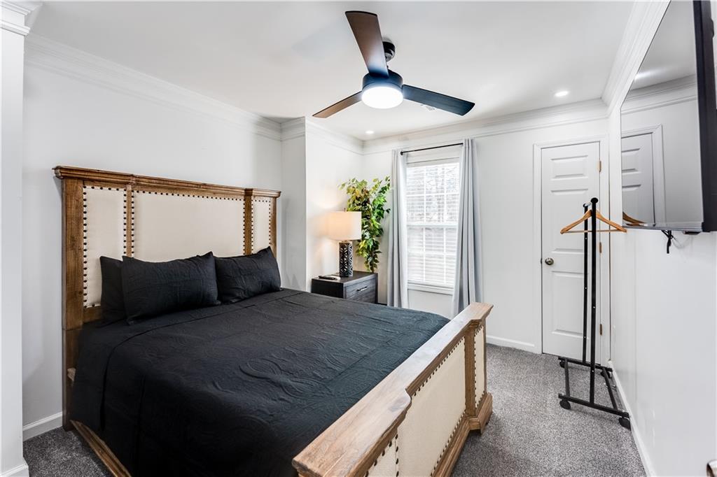 3135 Esplanade Circle Southwest Atlanta, GA 30311 - Photo 27 of 69 a bedroom with a large bed and a flat tv screen on dresser