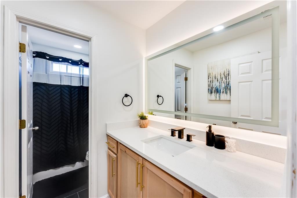 3135 Esplanade Circle Southwest Atlanta, GA 30311 - Photo 36 of 69 a bathroom with a sink and a mirror