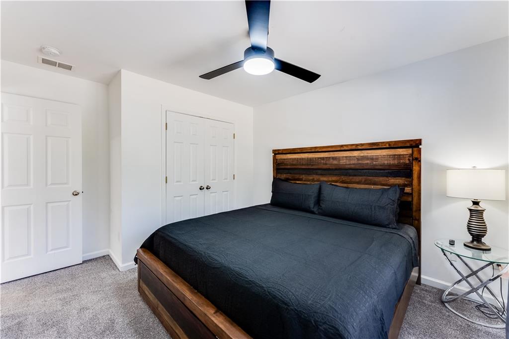 3135 Esplanade Circle Southwest Atlanta, GA 30311 - Photo 39 of 69 a bedroom with a bed and a chandelier