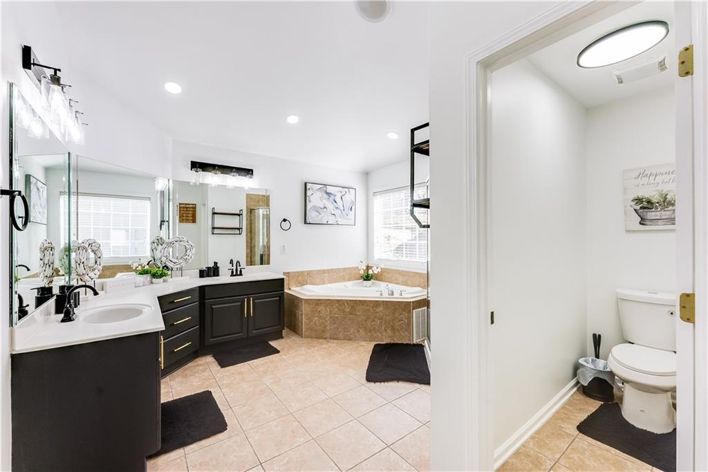 3135 Esplanade Circle Southwest Atlanta, GA 30311 - Photo 49 of 69 a large bathroom with a tub sink and mirror