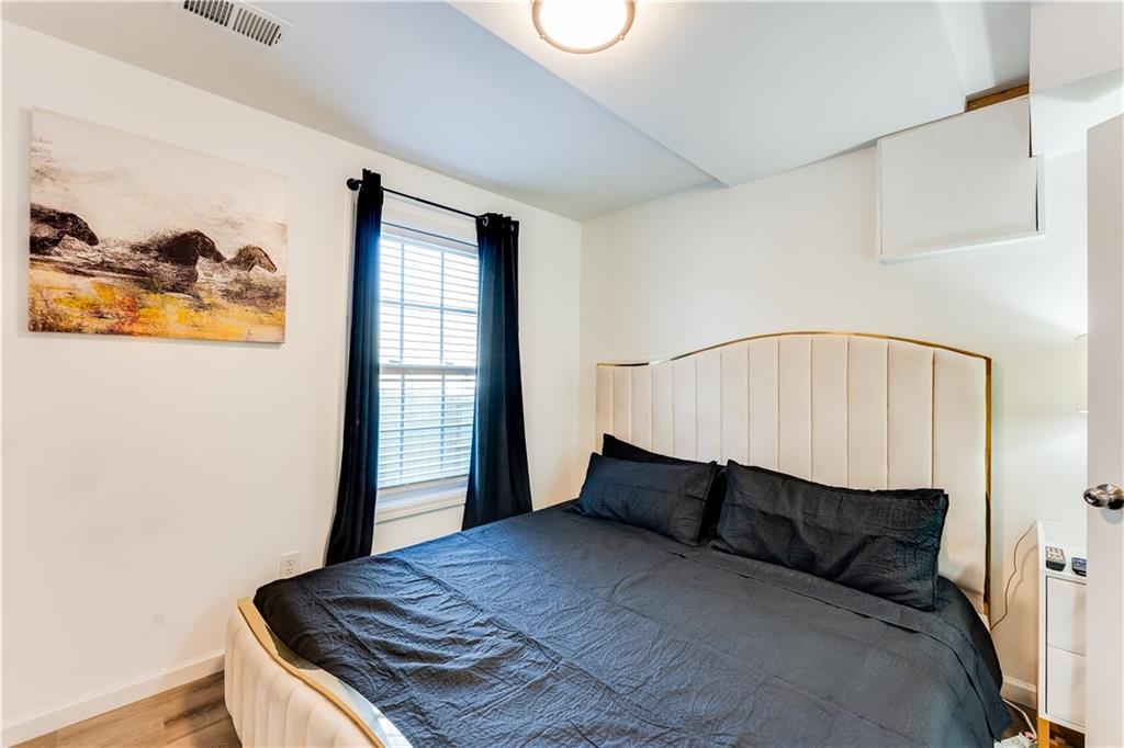 3135 Esplanade Circle Southwest Atlanta, GA 30311 - Photo 58 of 69 a bedroom with a bed and wooden floor