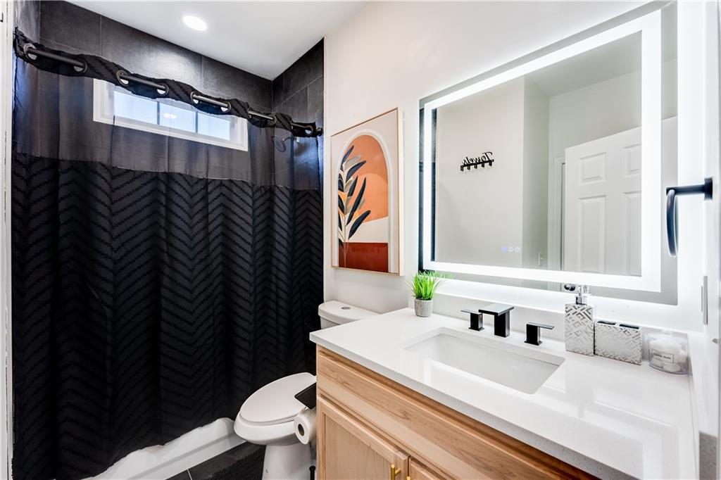 3135 Esplanade Circle Southwest Atlanta, GA 30311 - Photo 10 of 69 a bathroom with a sink a toilet and shower