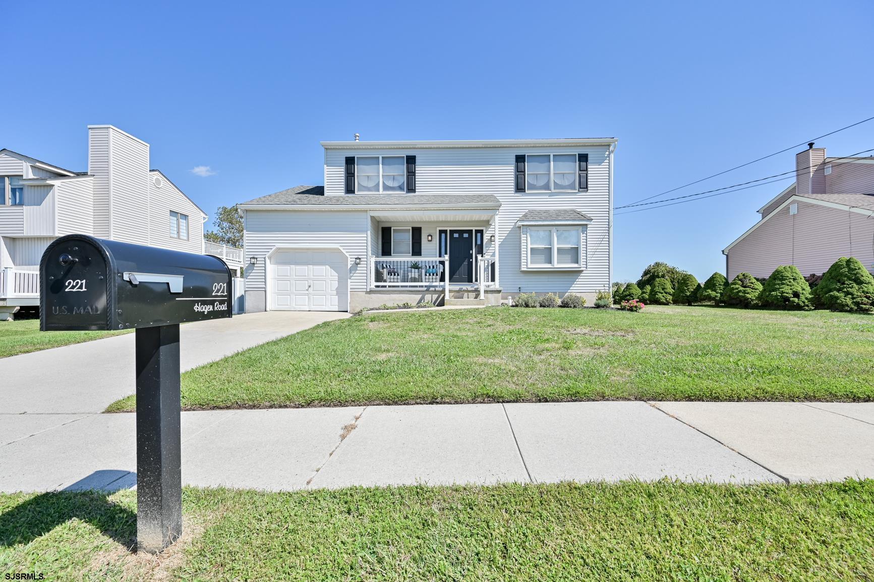 221 Hagen Road Brigantine, NJ 08203 - Photo 1 of 32 a front view of a house with a yard and garage