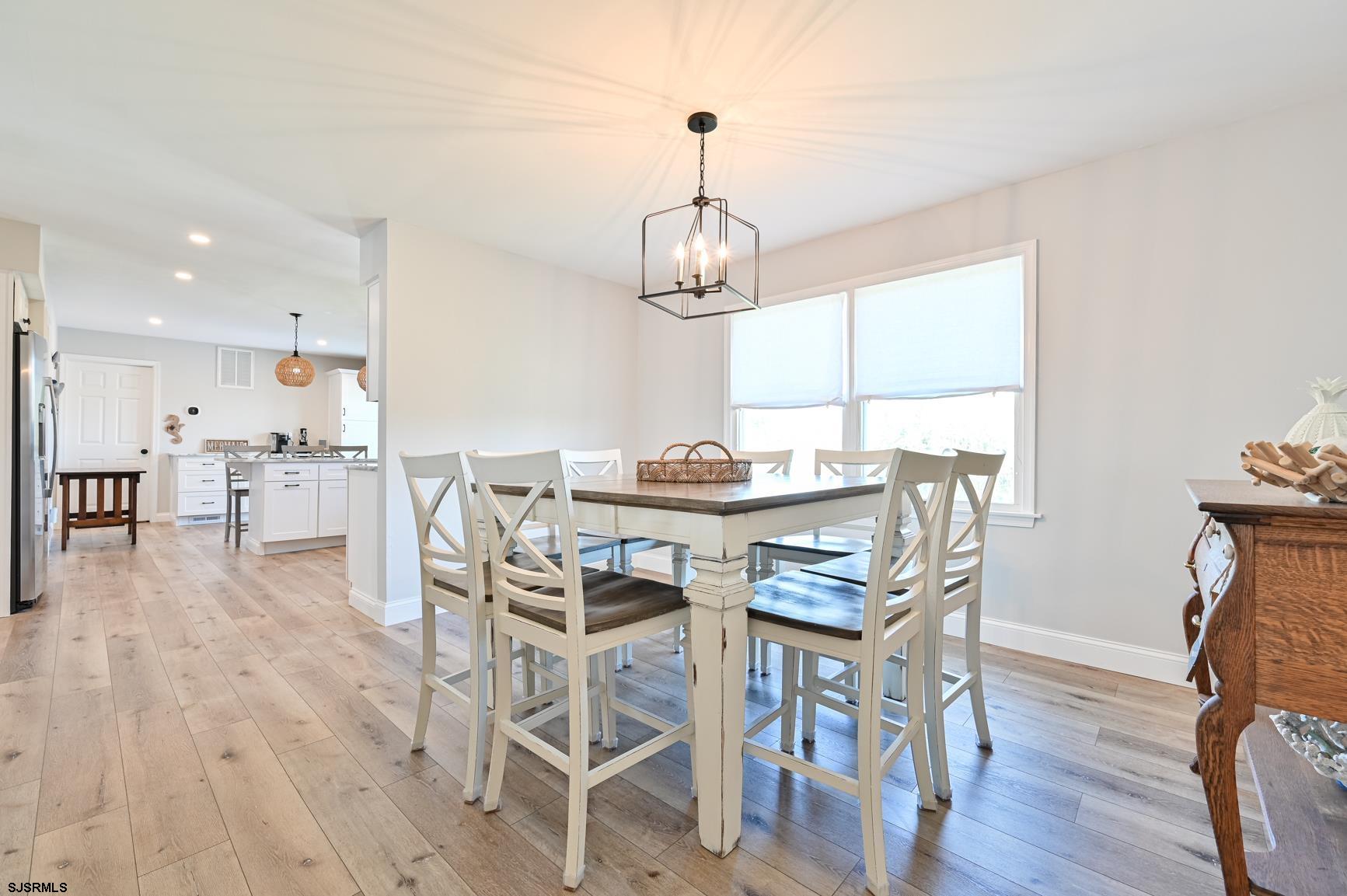 221 Hagen Road Brigantine, NJ 08203 - Photo 11 of 32 a view of a dining room with furniture window and wooden floor