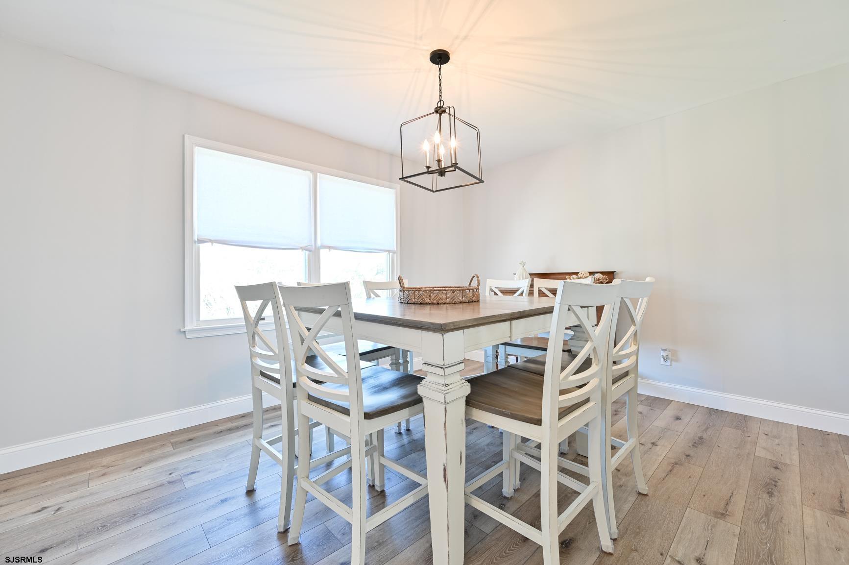221 Hagen Road Brigantine, NJ 08203 - Photo 12 of 32 a view of a dining room with furniture wooden floor and chandelier