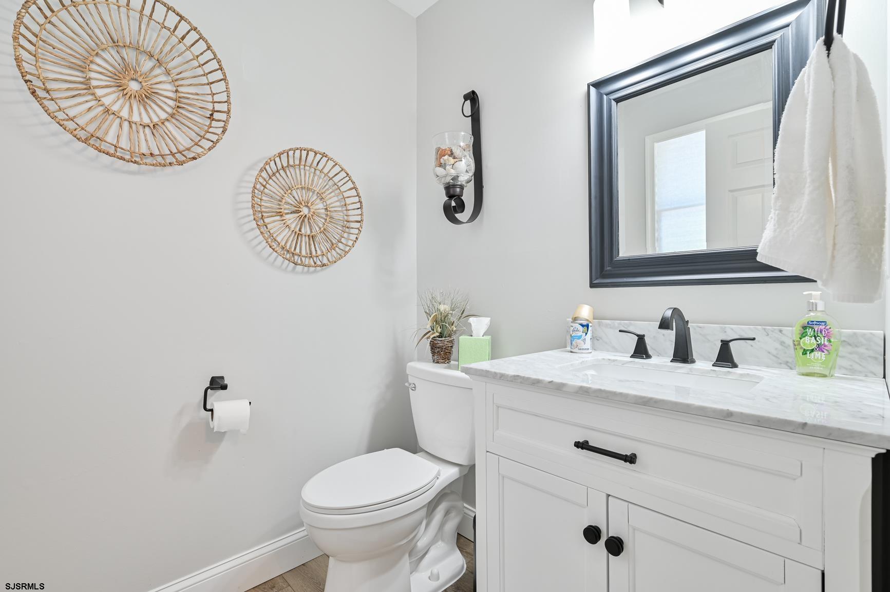221 Hagen Road Brigantine, NJ 08203 - Photo 13 of 32 a bathroom with a granite countertop toilet sink and a mirror