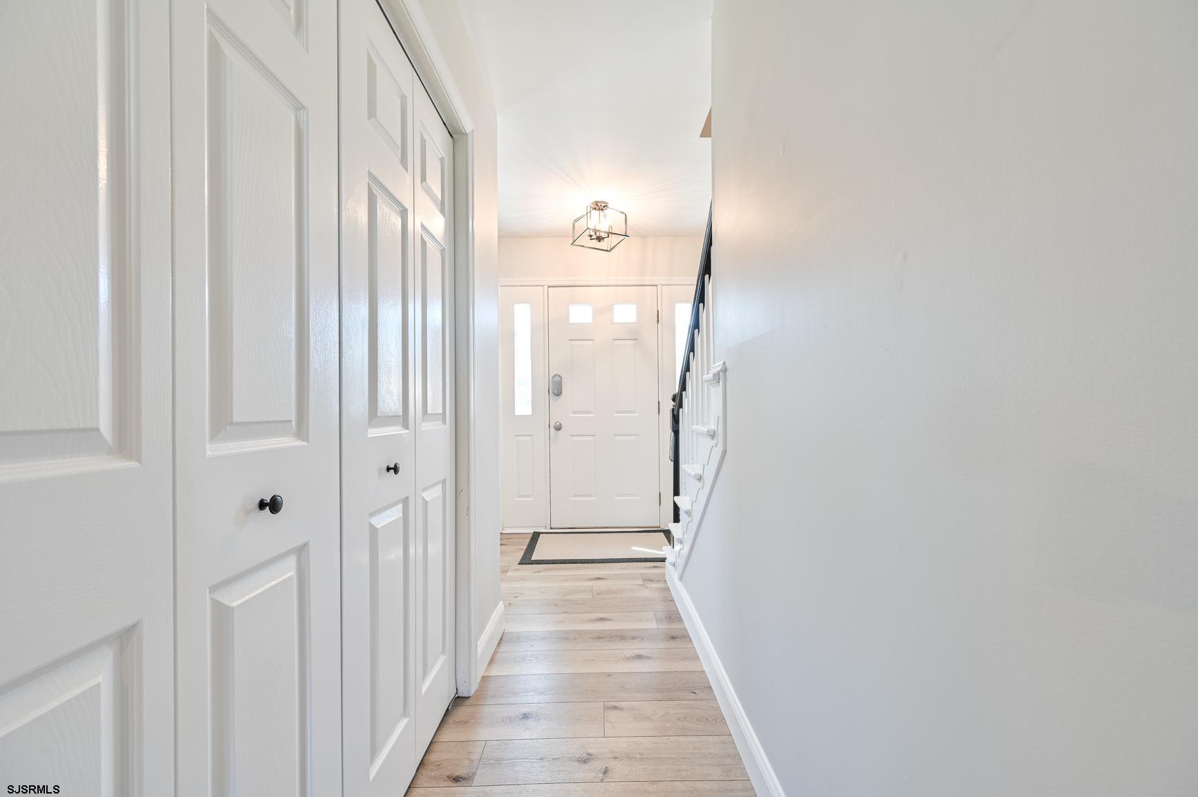 221 Hagen Road Brigantine, NJ 08203 - Photo 16 of 32 a view of a hallway with wooden floor and staircase