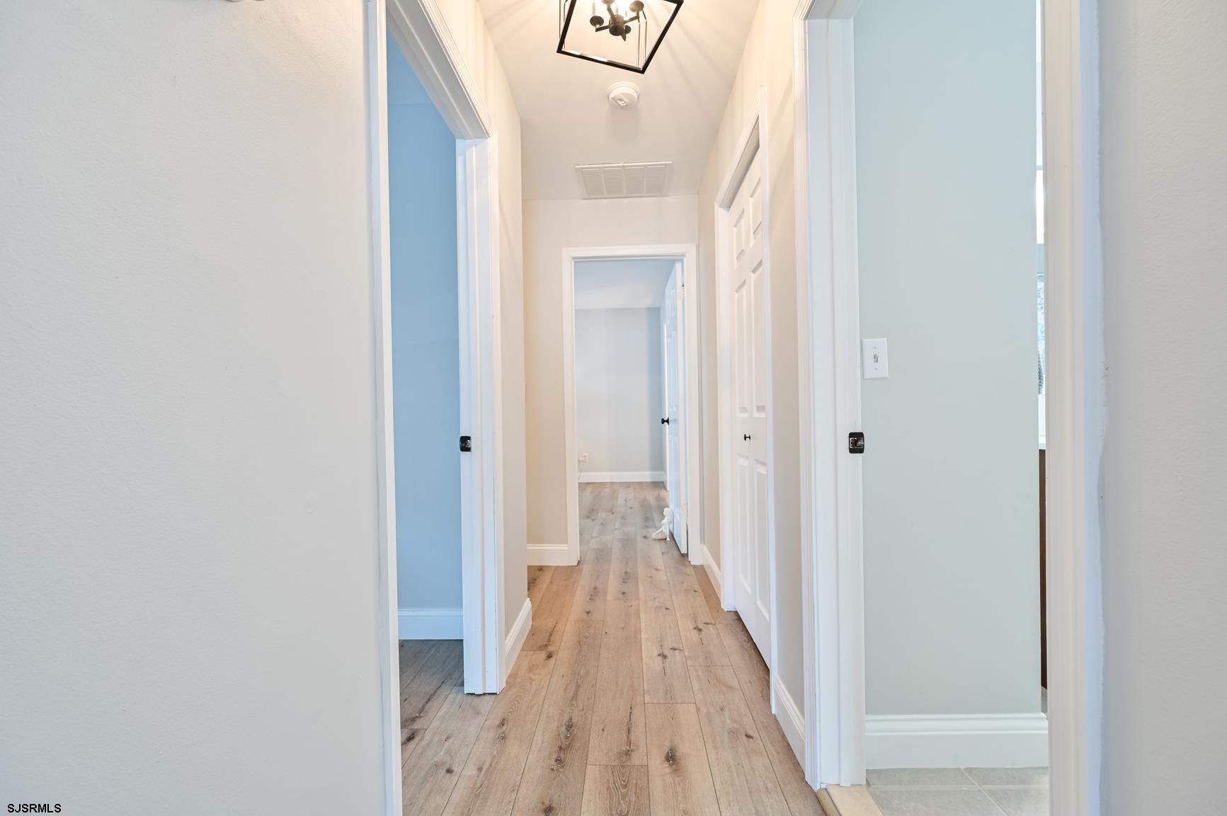 221 Hagen Road Brigantine, NJ 08203 - Photo 18 of 32 a view of a hallway with wooden floor