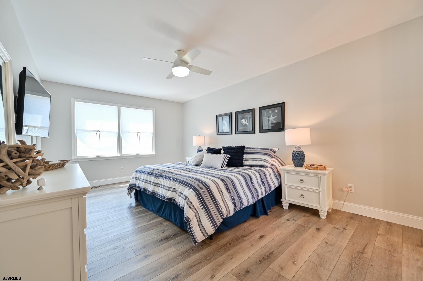 221 Hagen Road Brigantine, NJ 08203 - Photo 19 of 32 a bedroom with a bed and a flat screen tv