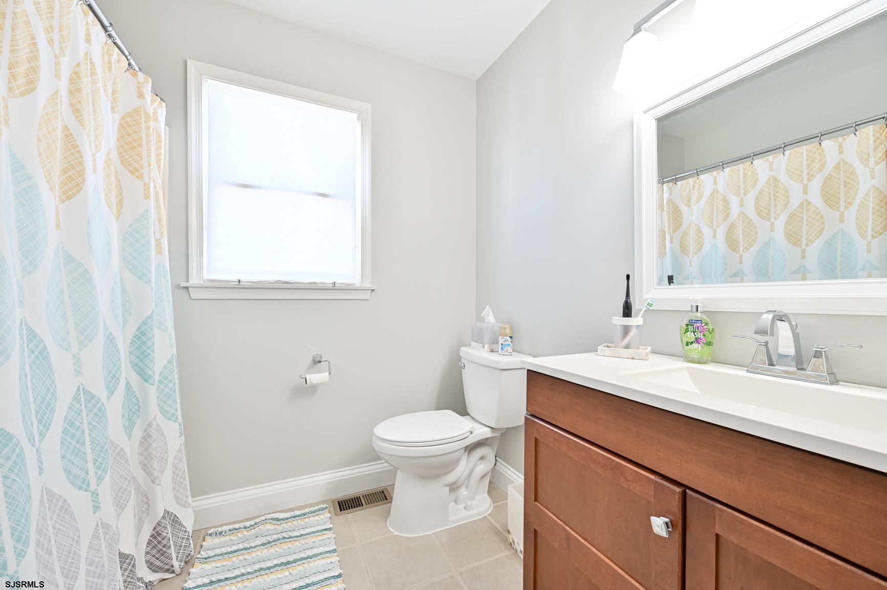 221 Hagen Road Brigantine, NJ 08203 - Photo 21 of 32 a bathroom with a granite countertop sink a toilet and a shower