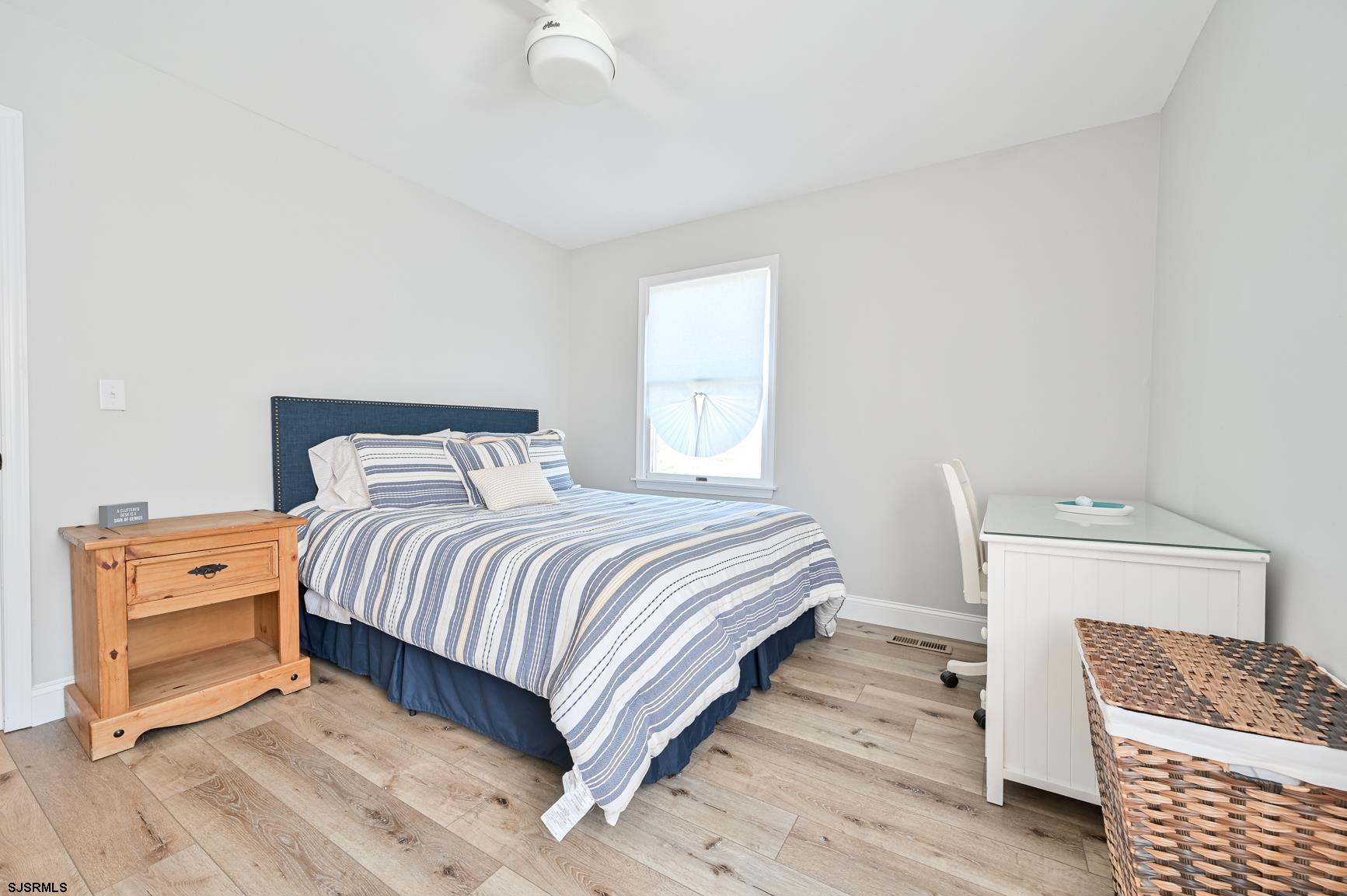 221 Hagen Road Brigantine, NJ 08203 - Photo 29 of 32 a bedroom with a bed and wooden floor
