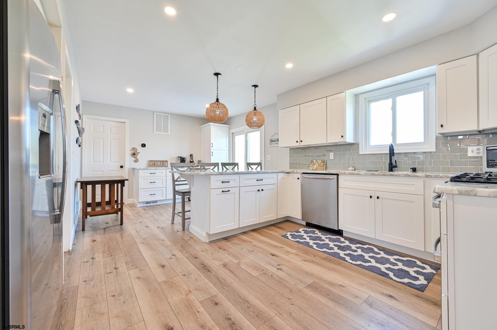221 Hagen Road Brigantine, NJ 08203 - Photo 6 of 32 a kitchen with a sink a window and cabinets