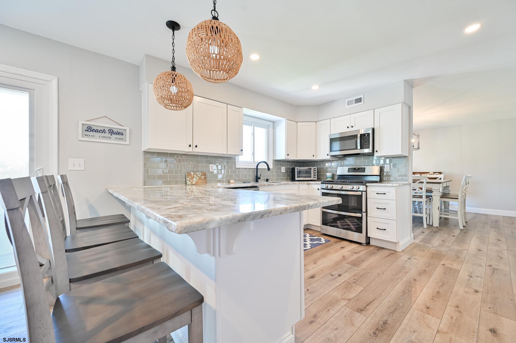 221 Hagen Road Brigantine, NJ 08203 - Photo 7 of 32 a kitchen with wooden cabinets and stainless steel appliances