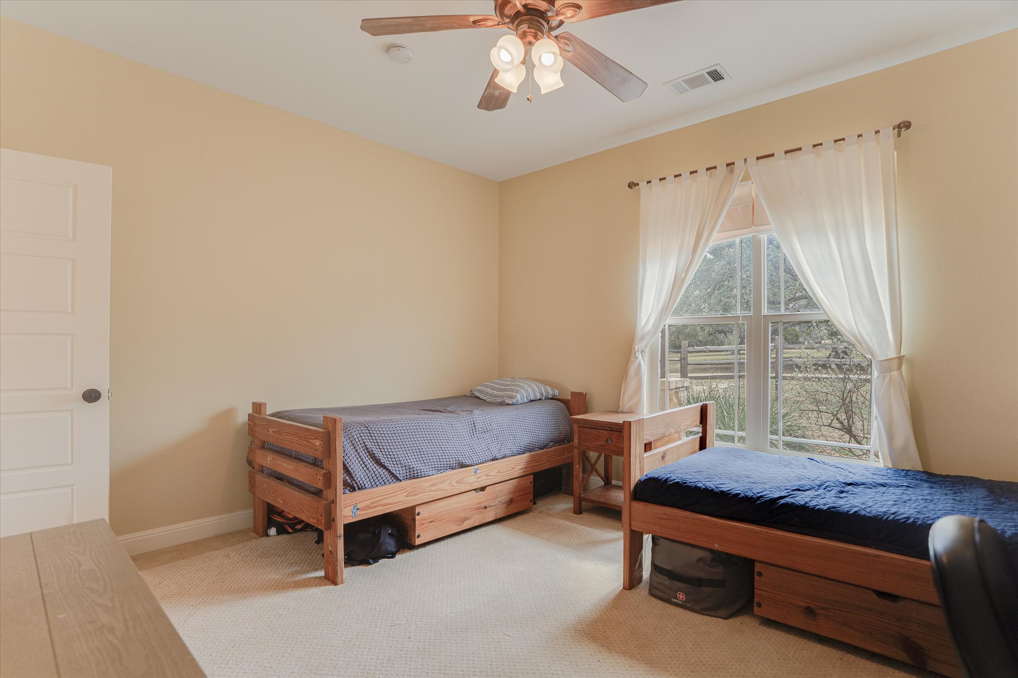 3501 Pursley Road Dripping Springs, TX 78620 - Photo 18 of 38 a bedroom with furniture and a window
