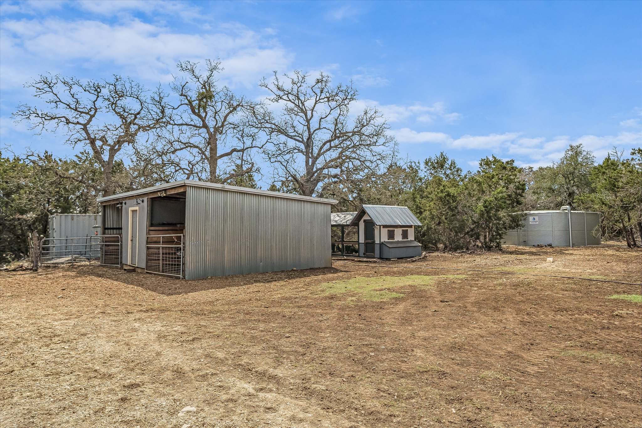 3501 Pursley Road Dripping Springs, TX 78620 - Photo 30 of 38 a front view of a house with a yard and garage