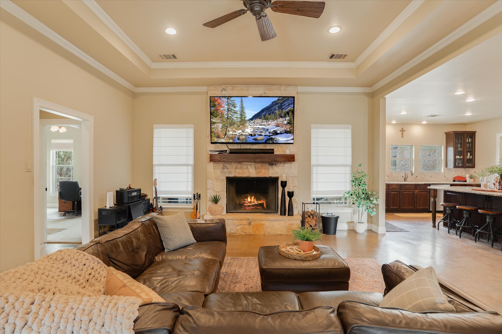 3501 Pursley Road Dripping Springs, TX 78620 - Photo 3 of 38 a living room with furniture a fireplace and a flat screen tv