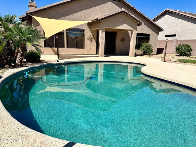 a view of a house with a backyard