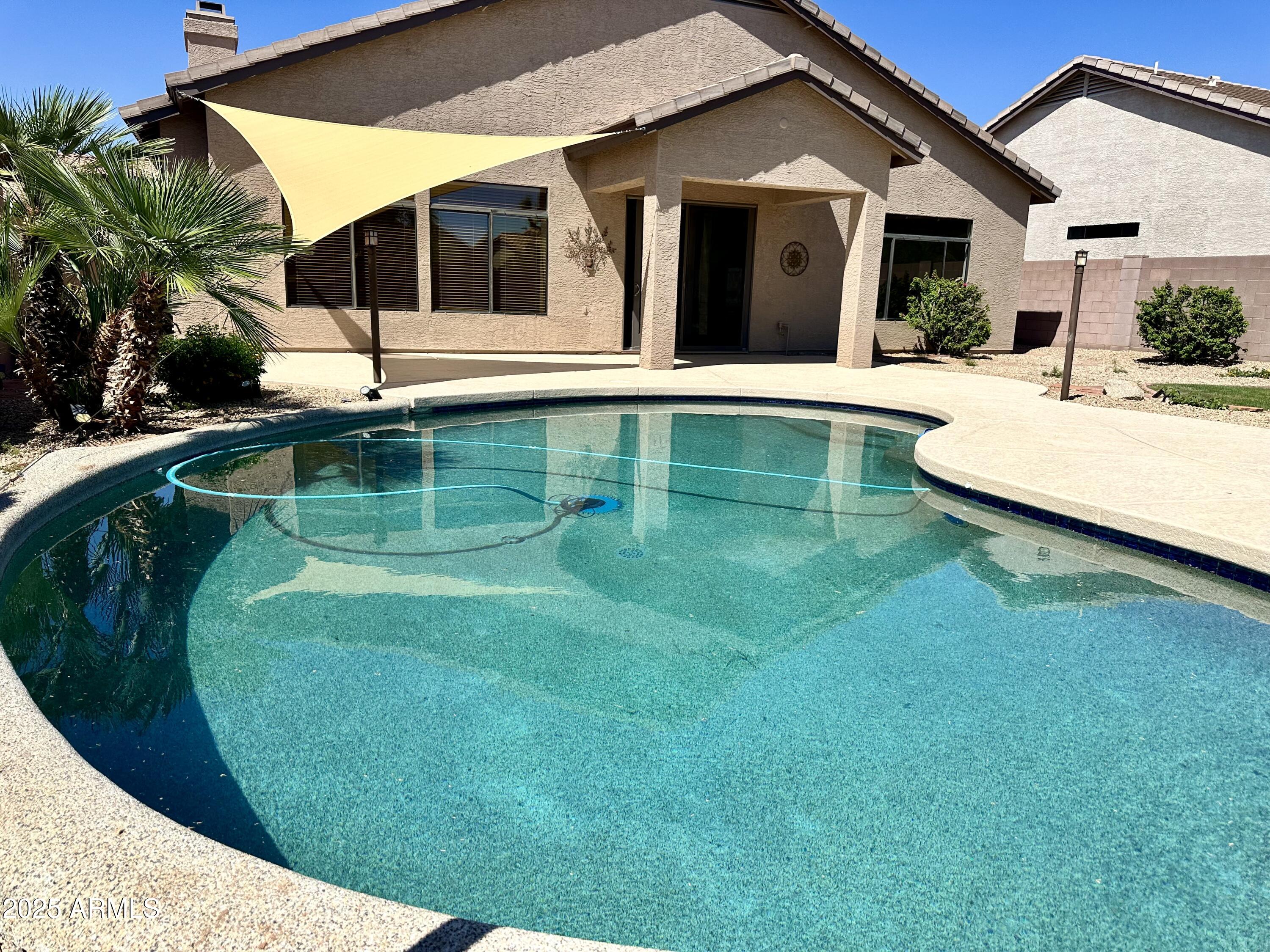 a view of a house with a backyard