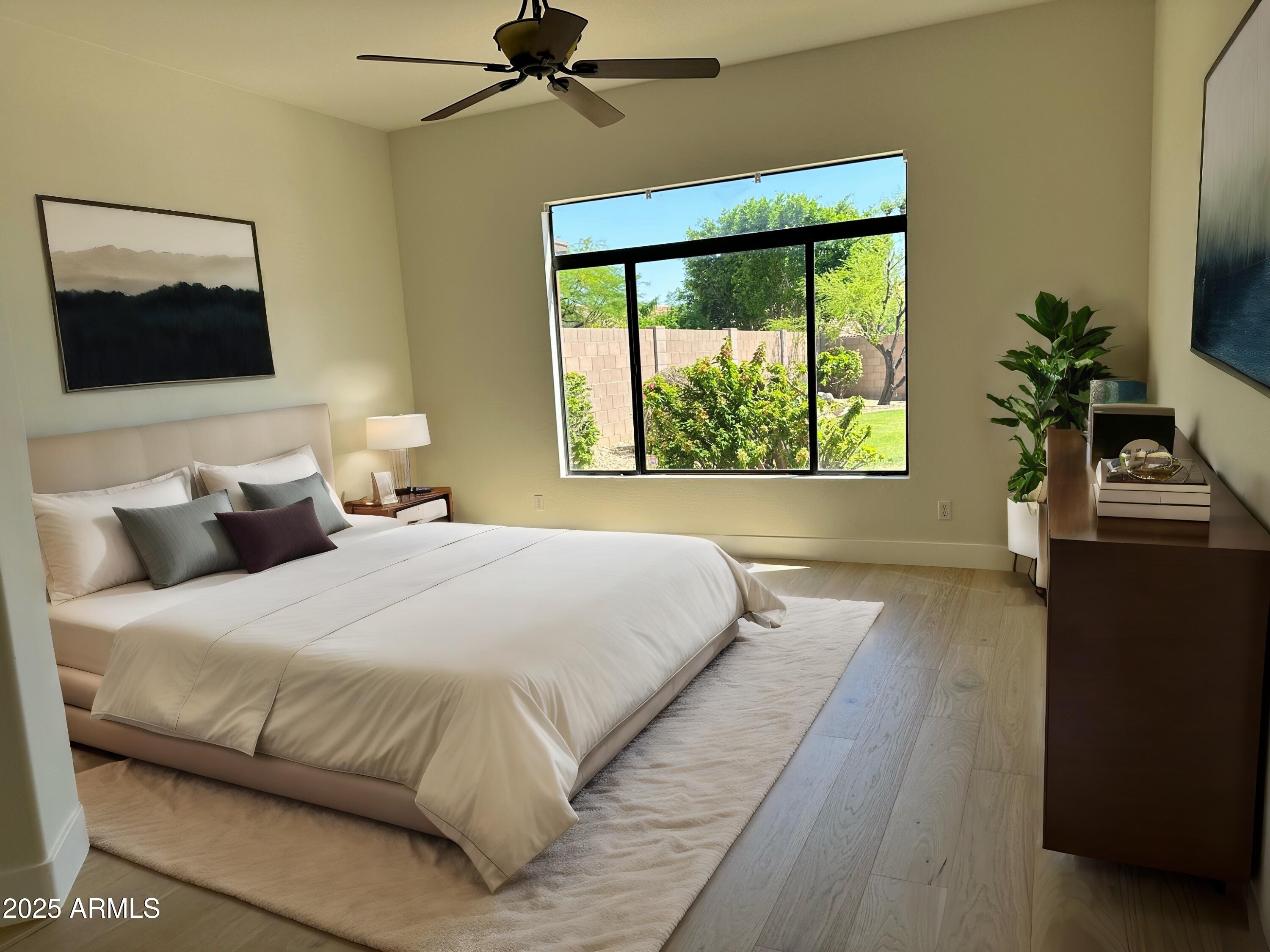 4303 East Hamblin Drive Phoenix, AZ 85050 - Photo 11 of 16 a bedroom with a bed and a flat tv screen on dresser
