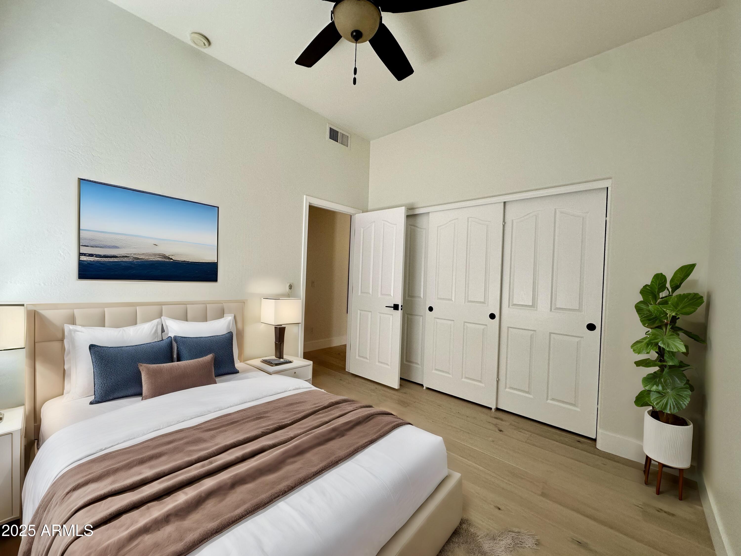 4303 East Hamblin Drive Phoenix, AZ 85050 - Photo 13 of 16 a bedroom with a bed and a potted plant