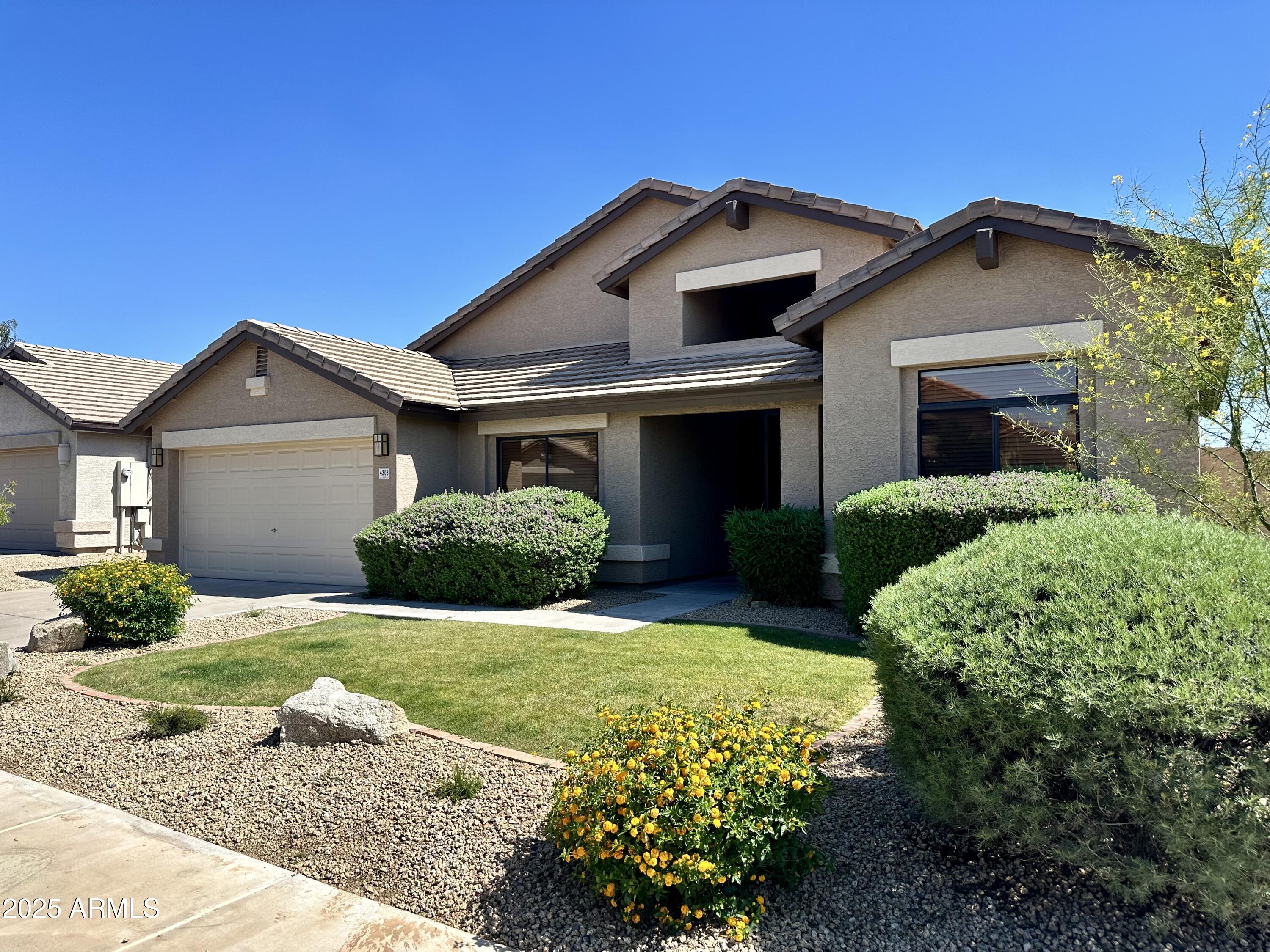 4303 East Hamblin Drive Phoenix, AZ 85050 - Photo 14 of 16 a front view of a house with a yard