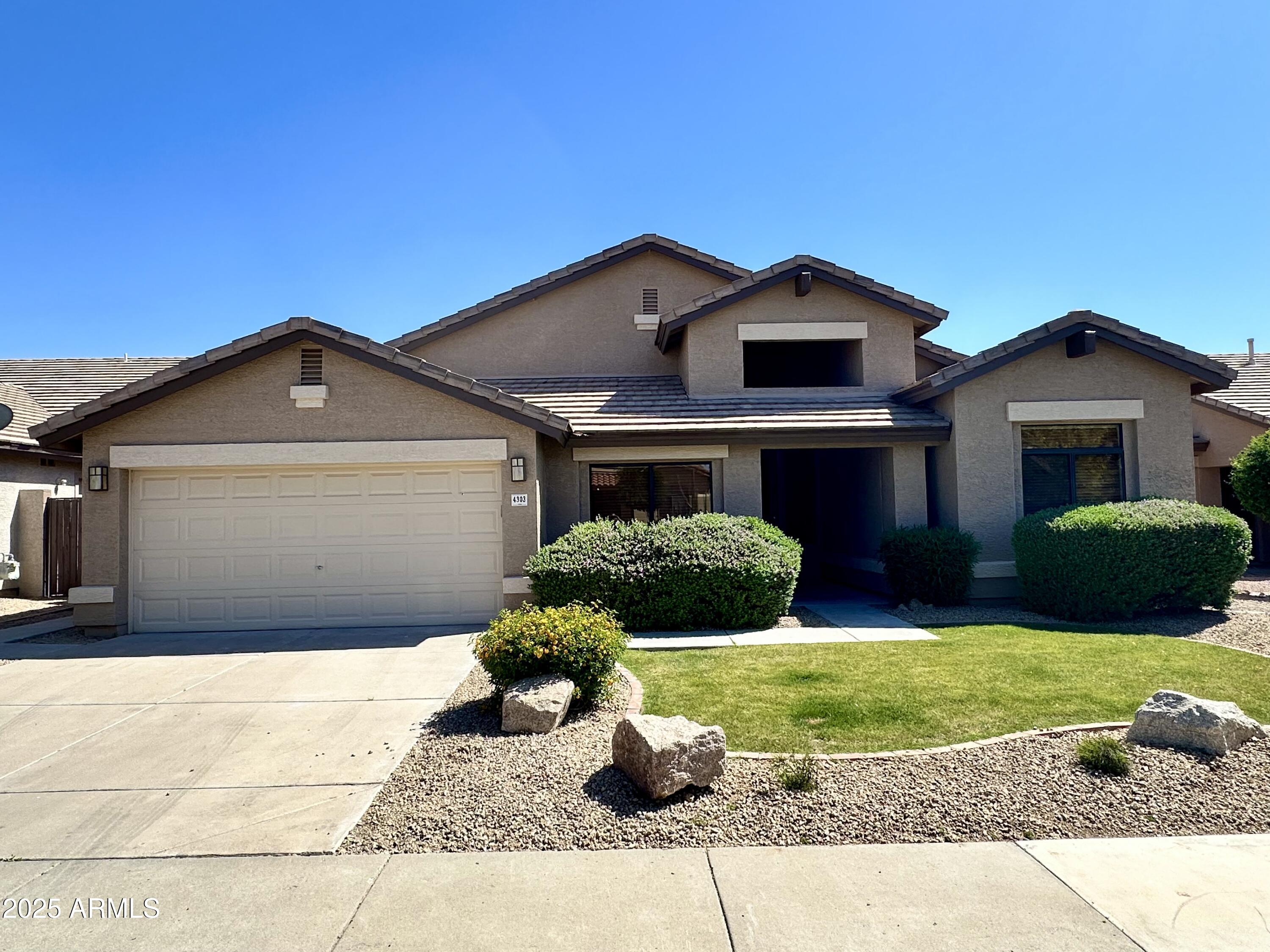 4303 East Hamblin Drive Phoenix, AZ 85050 - Photo 15 of 16 a front view of a house with a yard and garage
