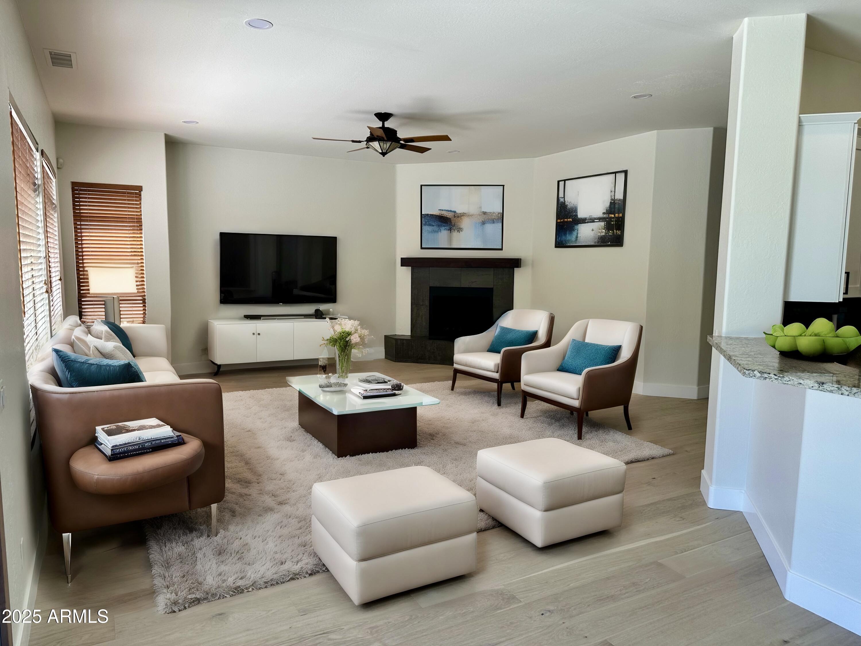 4303 East Hamblin Drive Phoenix, AZ 85050 - Photo 16 of 16 a living room with furniture a flat screen tv and a window