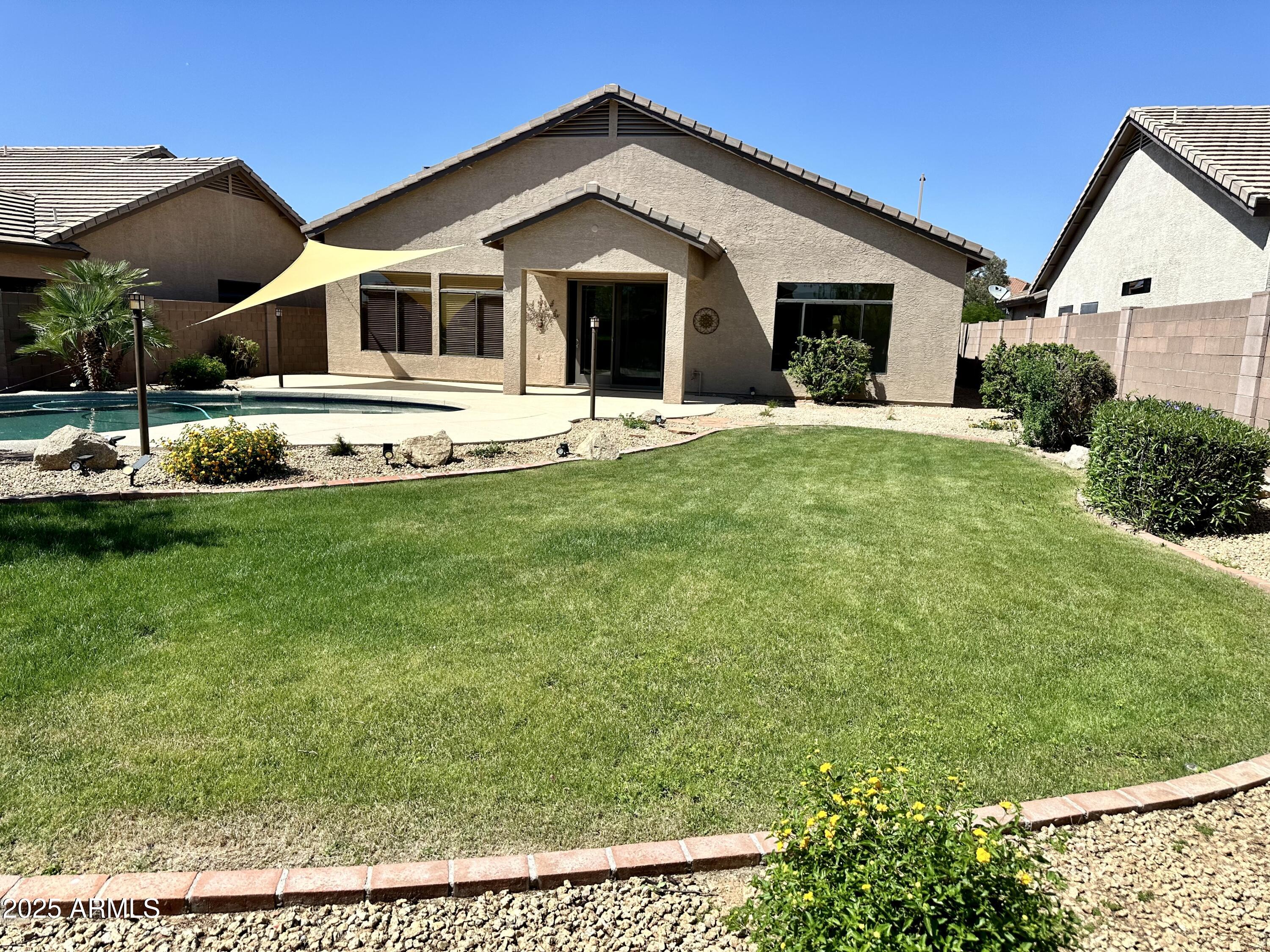 4303 East Hamblin Drive Phoenix, AZ 85050 - Photo 3 of 16 a front view of a house with a yard and potted plants