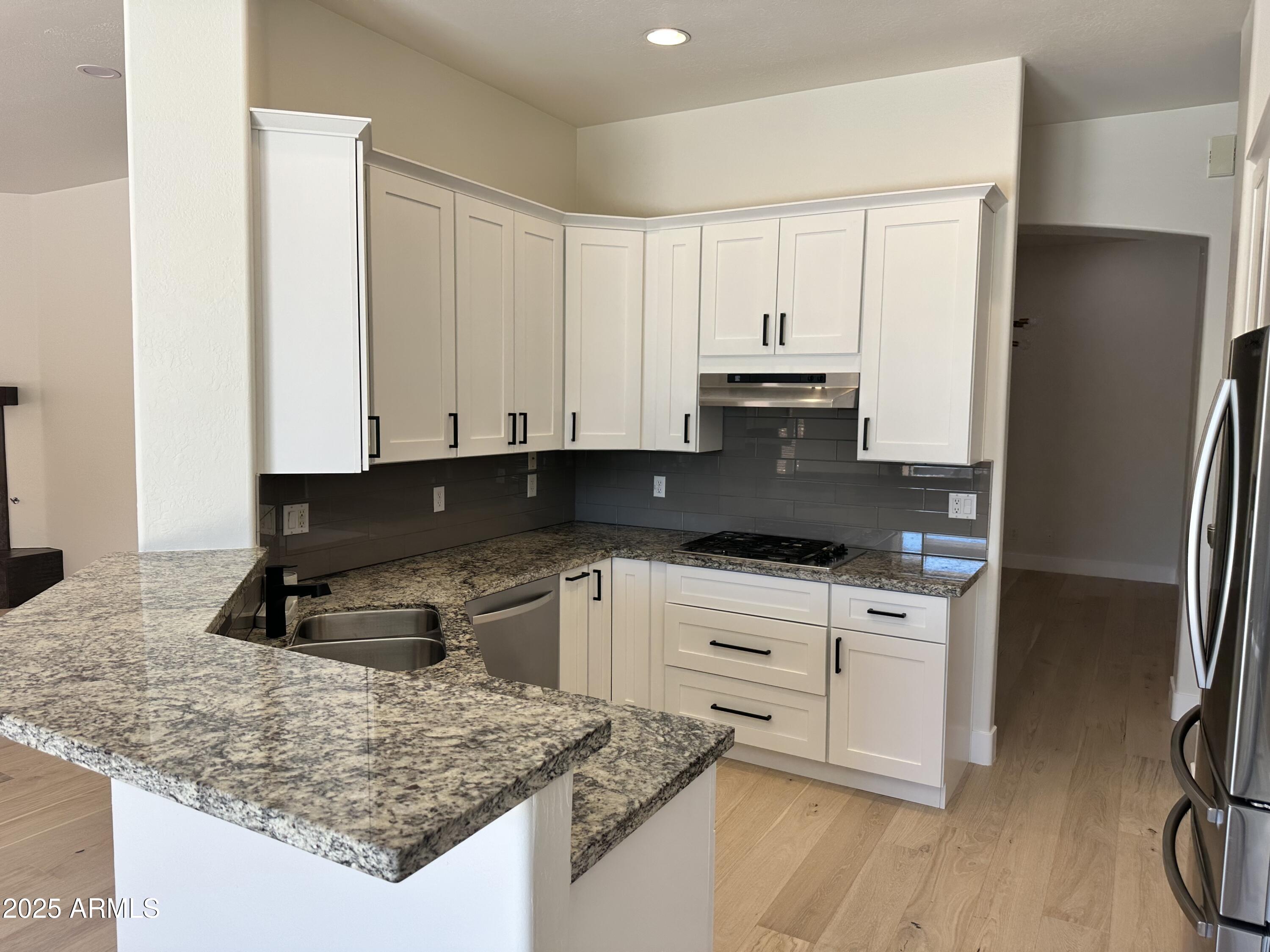 4303 East Hamblin Drive Phoenix, AZ 85050 - Photo 7 of 16 a kitchen with granite countertop a sink a stove and refrigerator