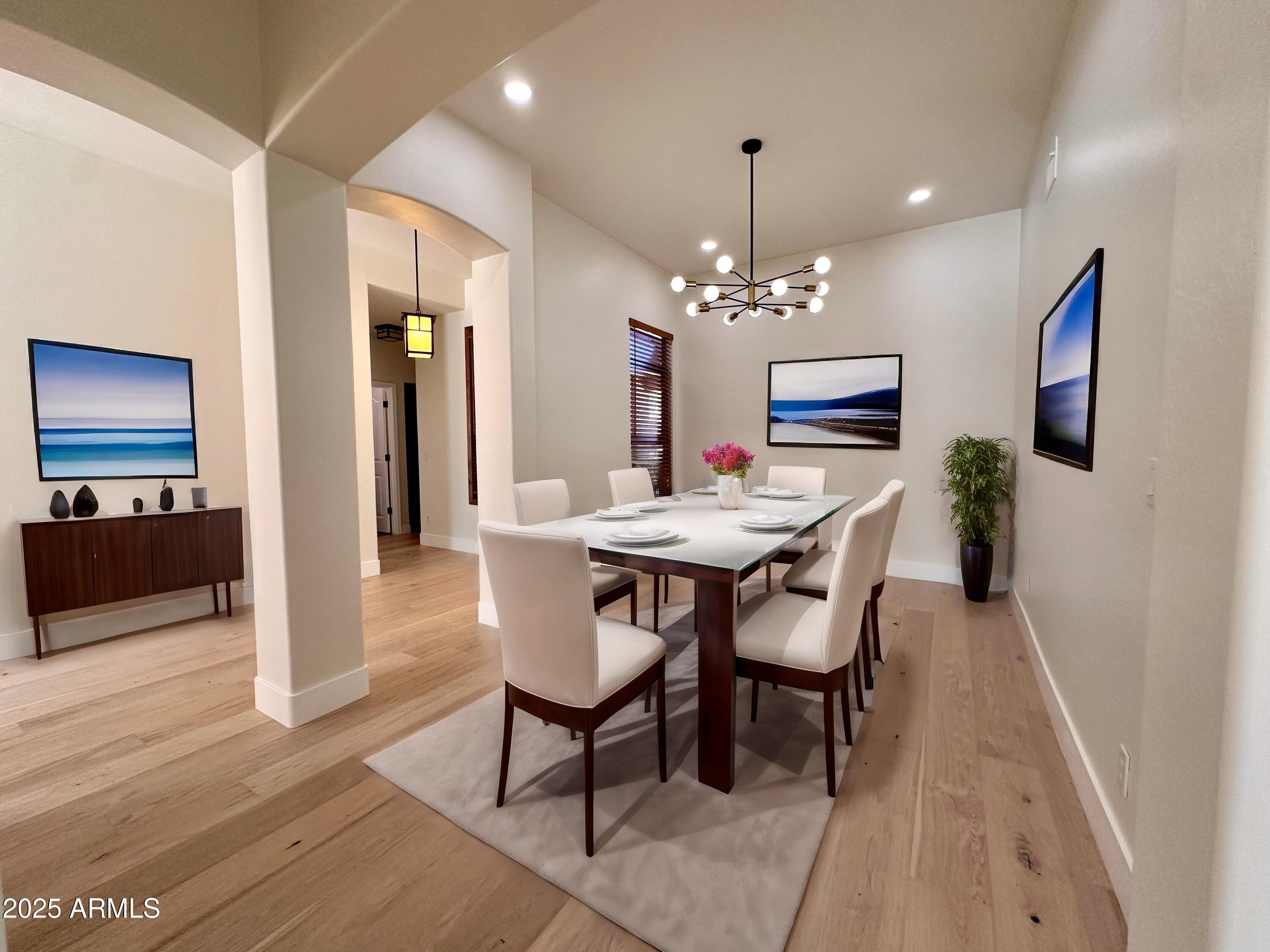 4303 East Hamblin Drive Phoenix, AZ 85050 - Photo 9 of 16 a dining room with furniture a chandelier and wooden floor