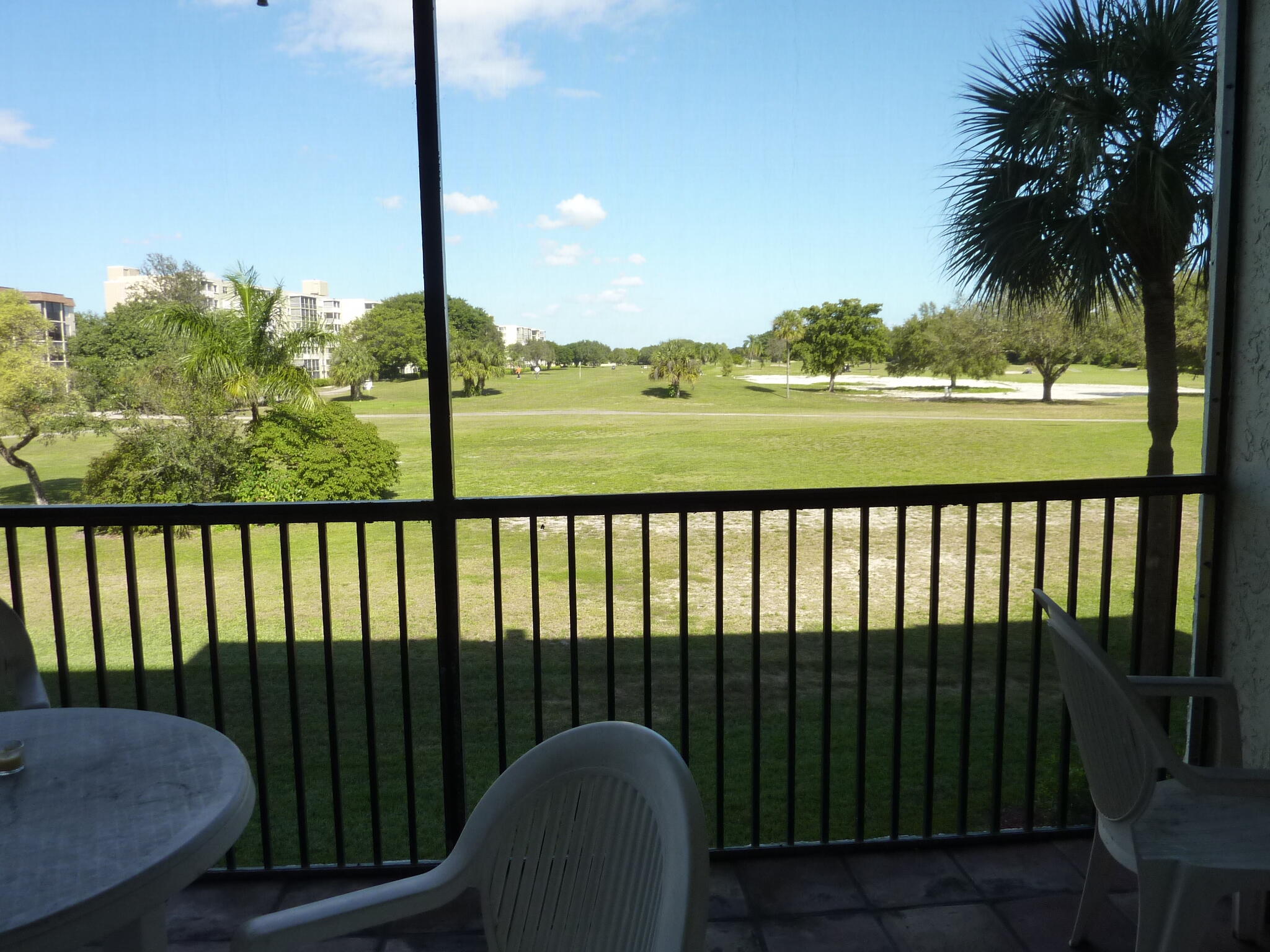 5280 Northwest 2nd Avenue, Unit 213 Boca Raton, FL 33487 - Photo 11 of 17 a view of a balcony with chair and table