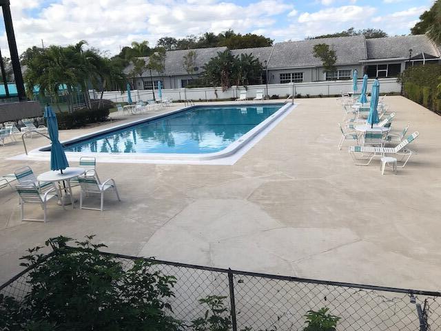 5280 Northwest 2nd Avenue, Unit 213 Boca Raton, FL 33487 - Photo 13 of 17 a view of a swimming pool with a patio